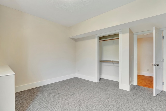 unfurnished bedroom featuring carpet flooring and a closet