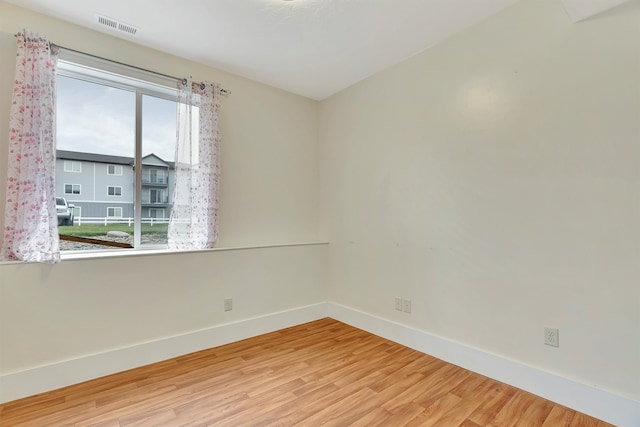 unfurnished room with wood-type flooring