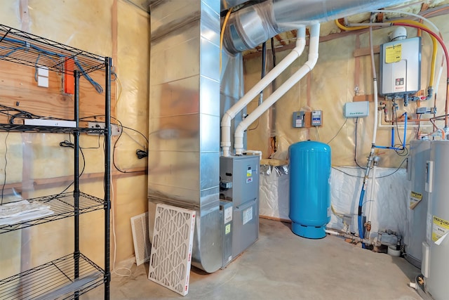 utility room with electric water heater and tankless water heater