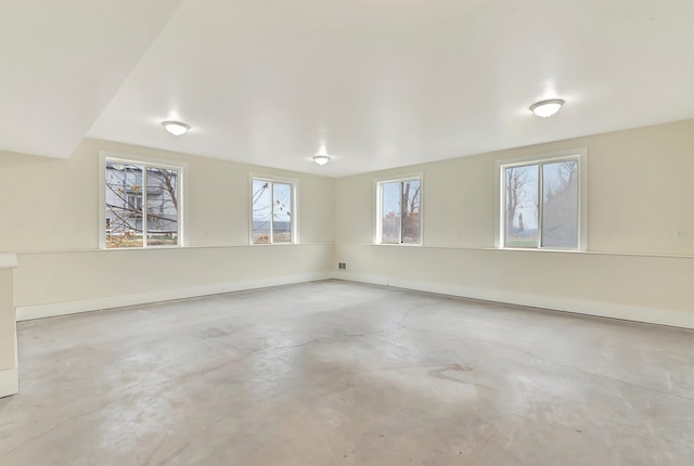 unfurnished room featuring concrete floors