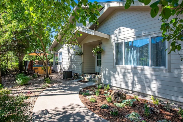 view of front of home with a patio and a jacuzzi