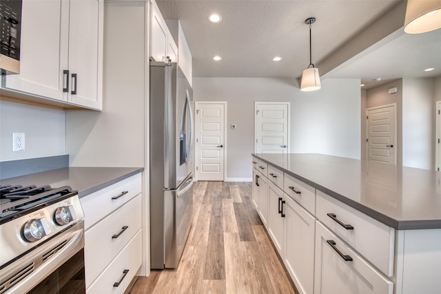 kitchen with white cabinetry, stainless steel appliances, light hardwood / wood-style floors, a textured ceiling, and decorative light fixtures