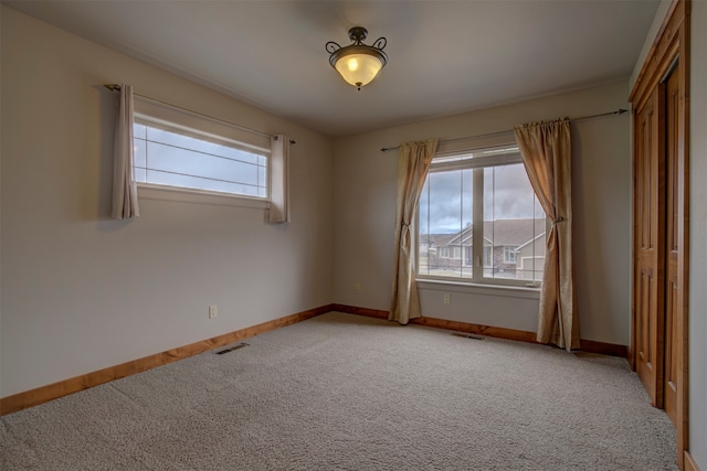 unfurnished room featuring carpet flooring