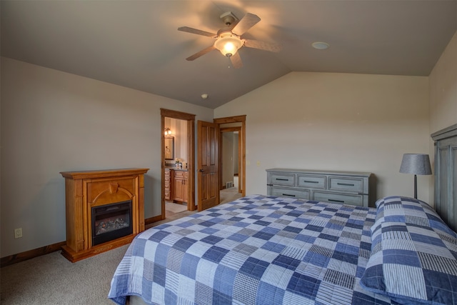 carpeted bedroom with ceiling fan, lofted ceiling, and ensuite bath