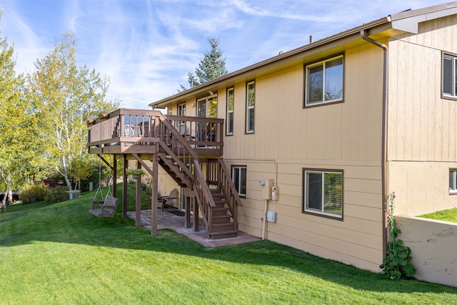 rear view of property with a lawn and a deck