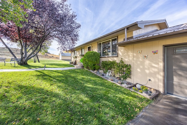 view of property exterior with a yard