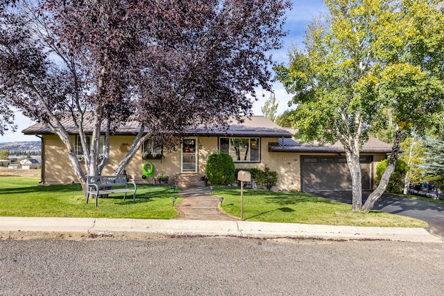 view of front of home with a front lawn and a garage