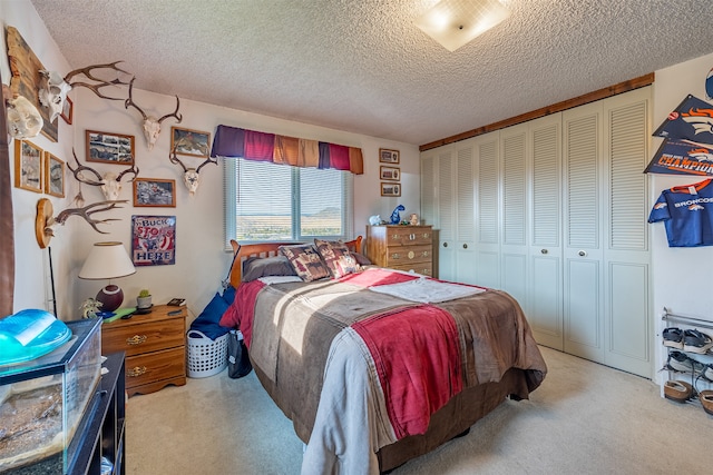 carpeted bedroom featuring a closet and a textured ceiling