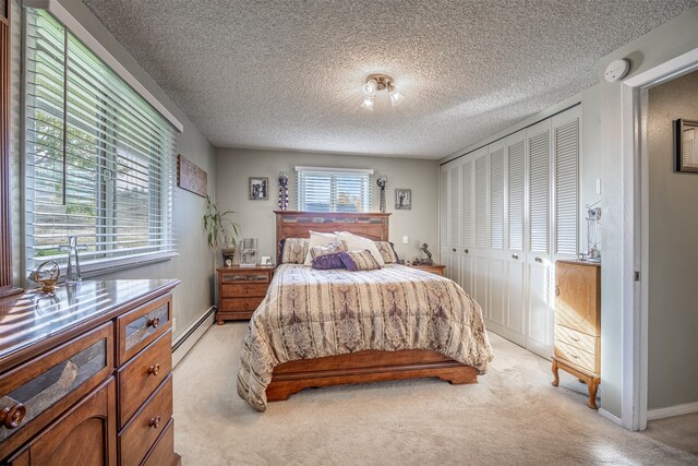 carpeted bedroom featuring a textured ceiling, a baseboard radiator, and a closet