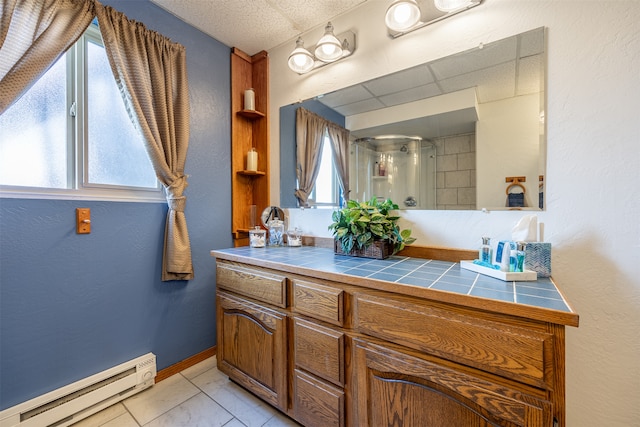 bathroom featuring tile patterned floors, vanity, a baseboard radiator, and walk in shower