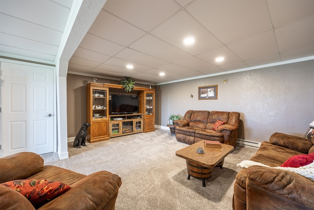 carpeted living room with ornamental molding and baseboard heating