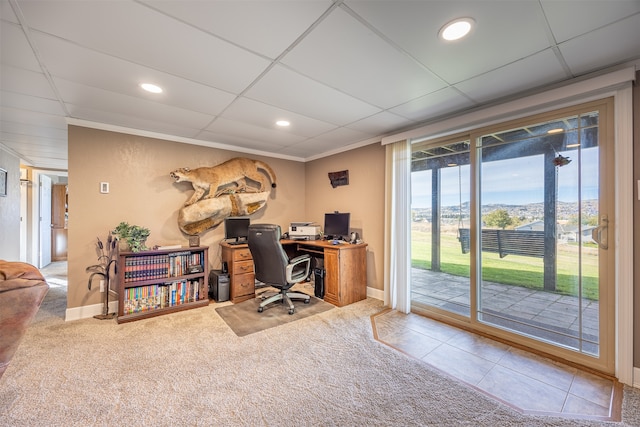 office space with tile patterned flooring, a paneled ceiling, and crown molding