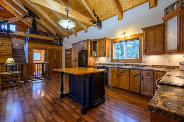 kitchen with a center island, dark hardwood / wood-style flooring, high vaulted ceiling, beamed ceiling, and black appliances