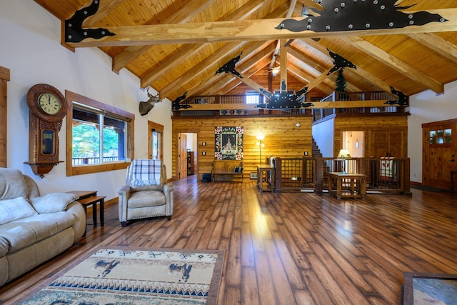 living room featuring ceiling fan, wood-type flooring, beam ceiling, high vaulted ceiling, and wood walls