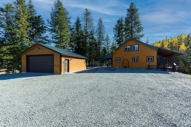 view of side of home featuring an outdoor structure and a garage