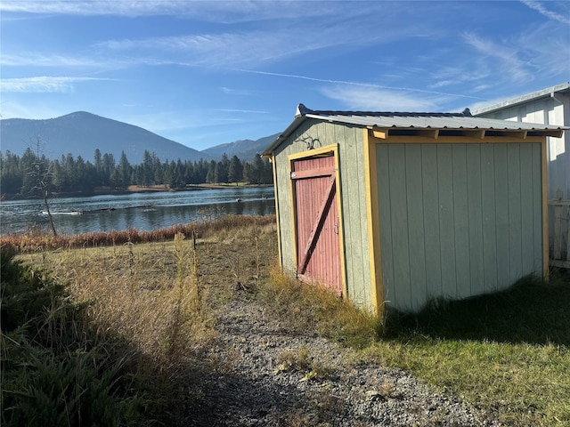 view of outdoor structure featuring a water and mountain view