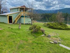 view of yard with a mountain view and stairway