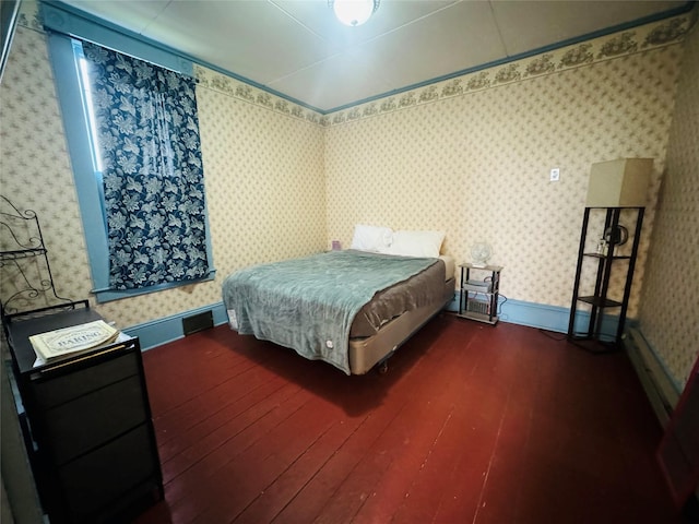 bedroom with dark hardwood / wood-style floors