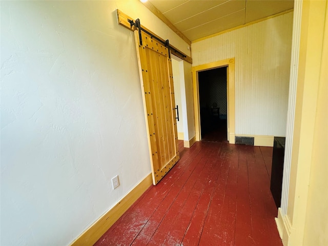 hall featuring dark hardwood / wood-style floors and a barn door