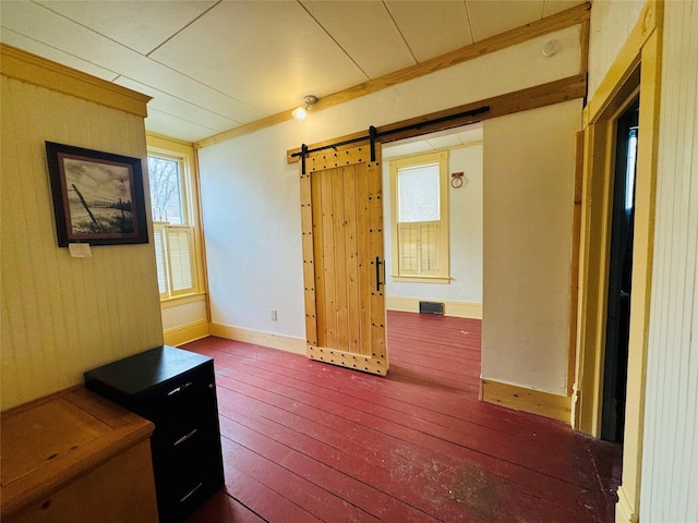 interior space featuring crown molding, a barn door, and dark hardwood / wood-style flooring