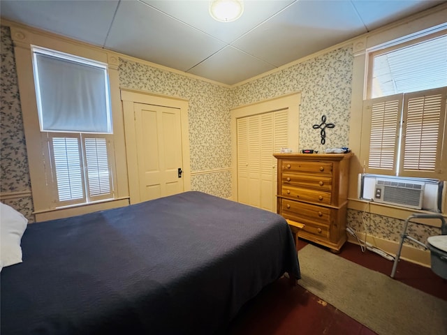 bedroom featuring multiple windows, ornamental molding, and cooling unit