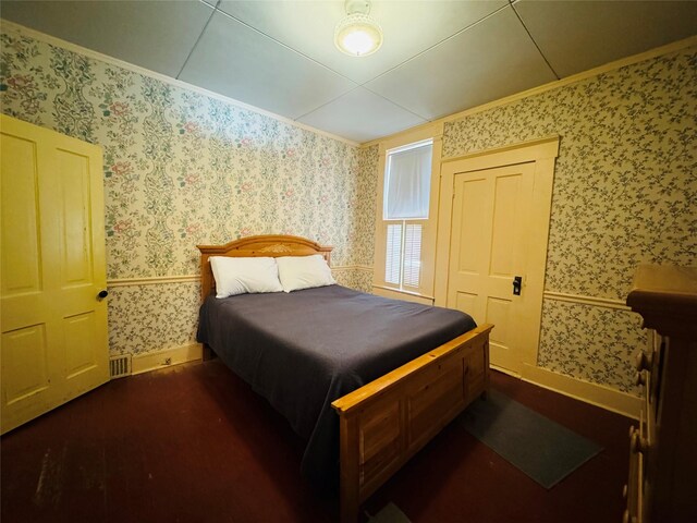 bedroom featuring wallpapered walls, ornamental molding, and cooling unit