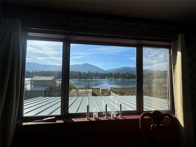 doorway with a wealth of natural light and a water and mountain view