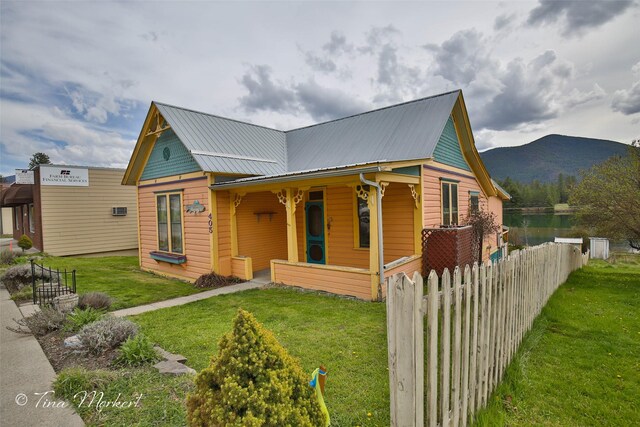 view of front of property with a mountain view and a front lawn