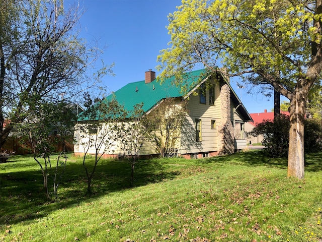 508 1st St W, Polson, MT 59860 - view of side of property with a chimney and a yard