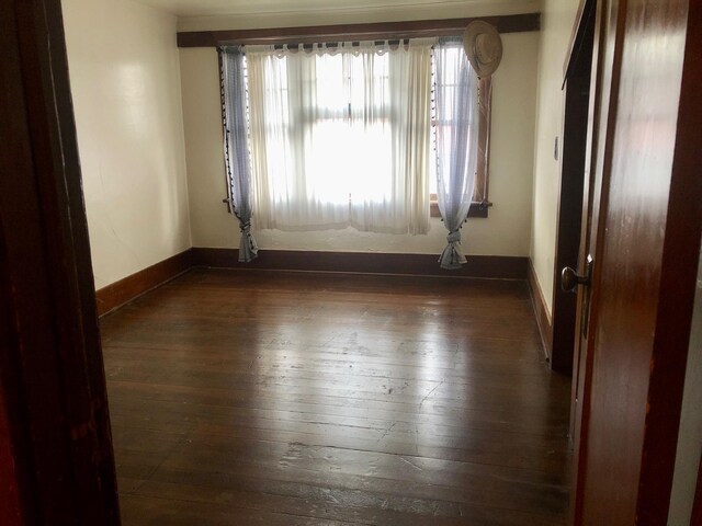 508 1st St W, Polson, MT 59860 - spare room with dark wood-style flooring and baseboards