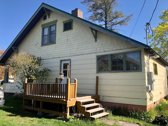 508 1st St W, Polson, MT 59860 - rear view of house featuring a deck and a chimney