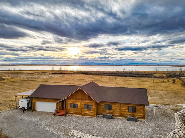 view of front of house featuring a mountain view, a rural view, and a garage