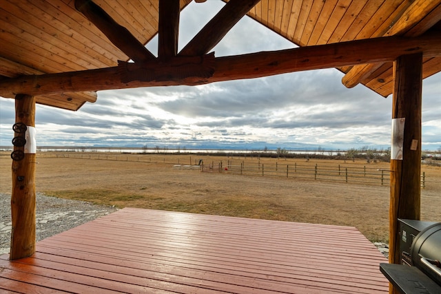 wooden deck with a rural view