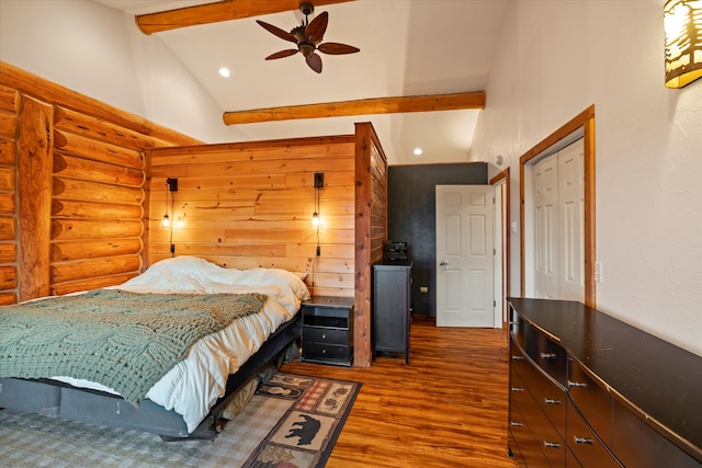 bedroom featuring high vaulted ceiling, dark hardwood / wood-style floors, ceiling fan, beam ceiling, and a closet