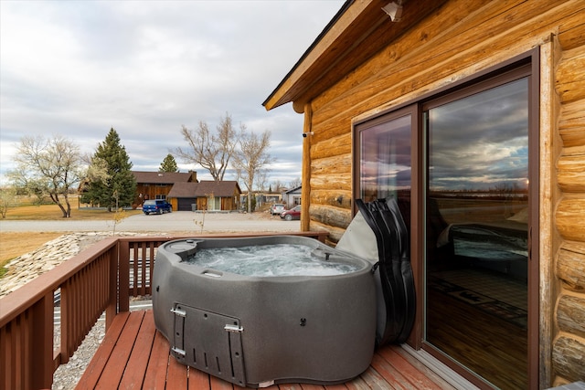 wooden deck featuring a hot tub