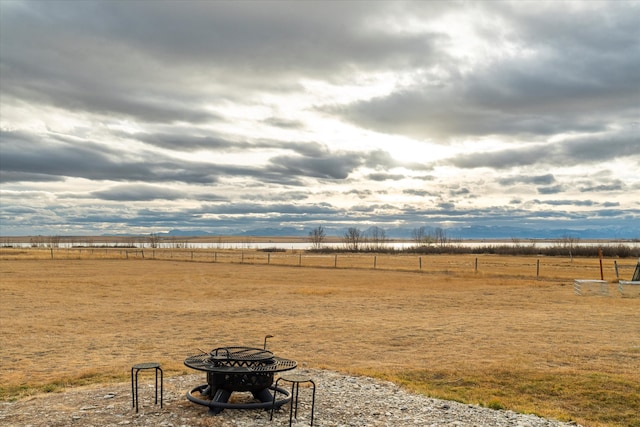 view of yard featuring a fire pit and a rural view