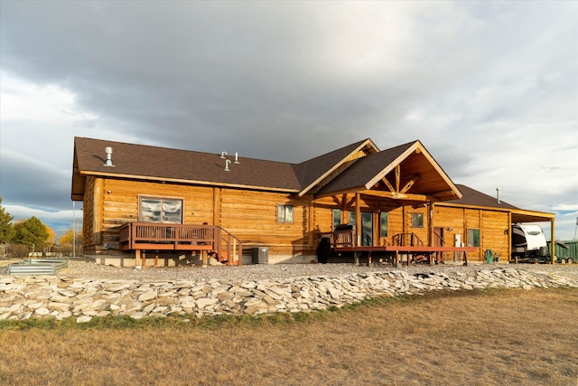 rear view of house featuring a deck