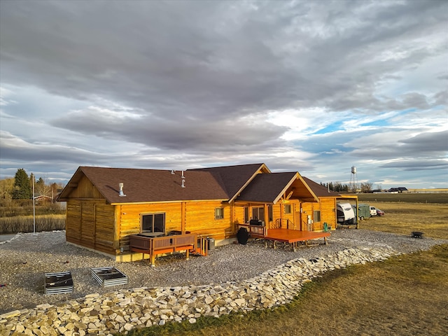 back of property featuring a deck