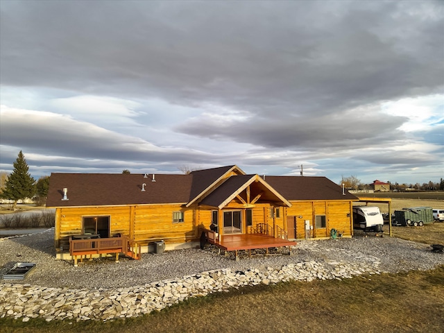 back of property with a wooden deck