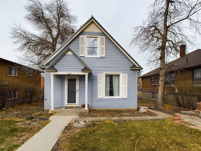 bungalow-style house featuring a front yard