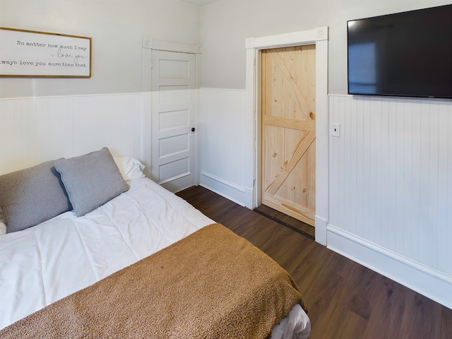 bedroom with dark wood-type flooring