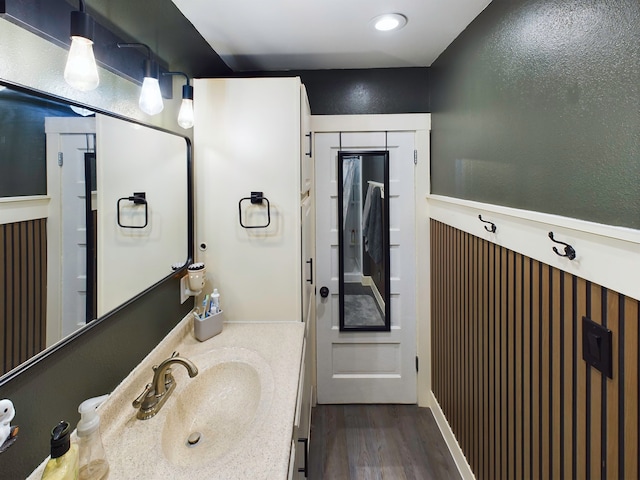 bathroom with vanity and hardwood / wood-style flooring