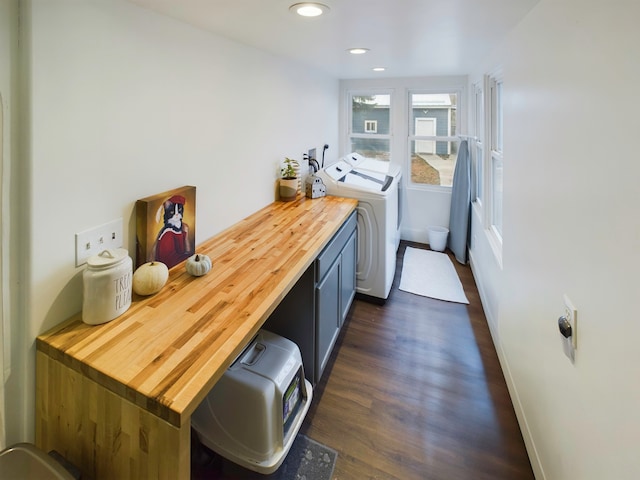 laundry area with cabinets, washer and clothes dryer, and dark wood-type flooring