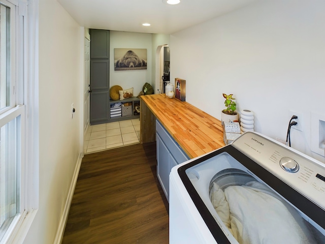 washroom with dark hardwood / wood-style flooring and washer / clothes dryer