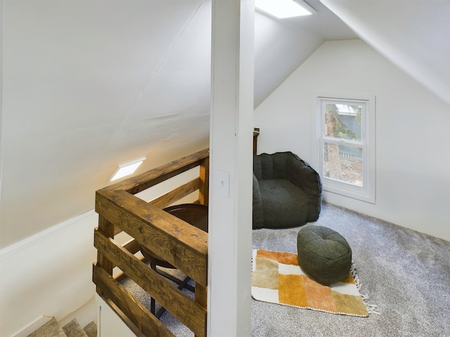 stairway featuring carpet flooring and lofted ceiling