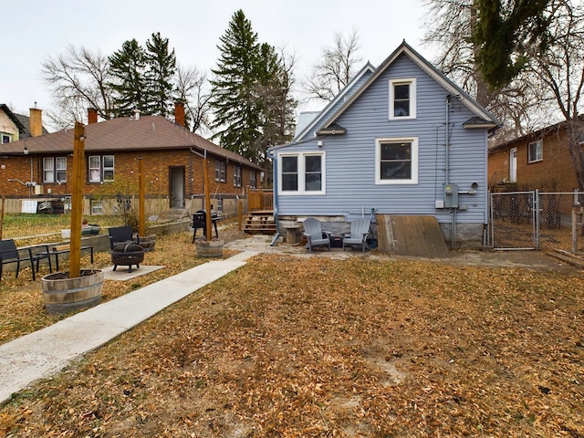 back of property featuring a fire pit