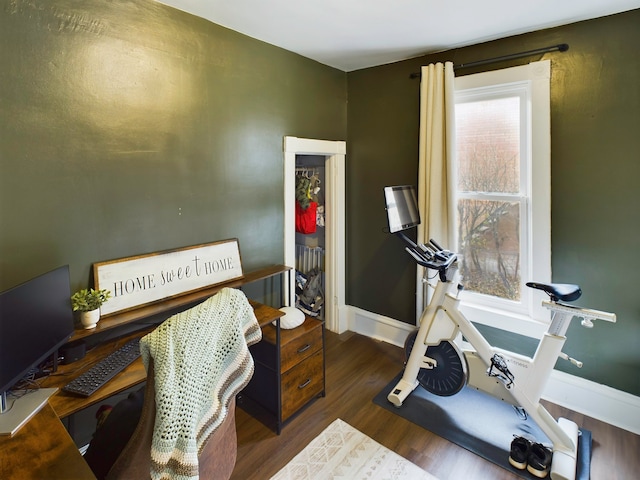 workout area with dark wood-type flooring