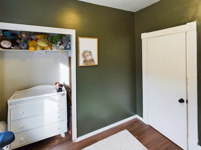 bedroom with dark hardwood / wood-style floors