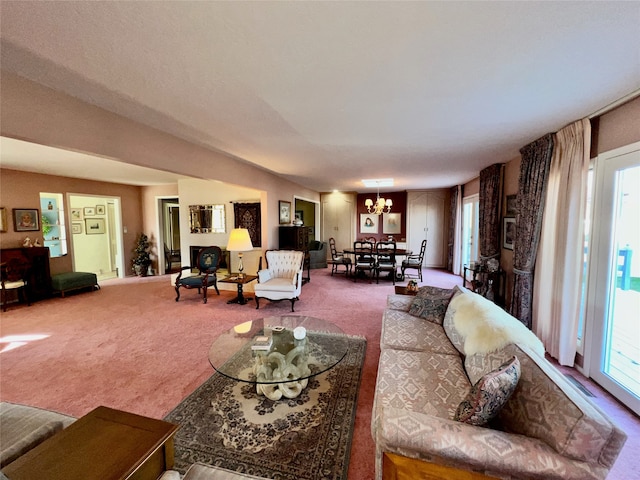 carpeted living room with an inviting chandelier