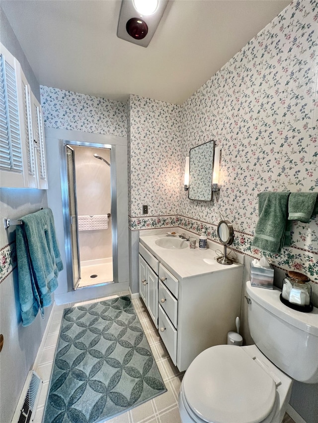 bathroom with vanity, toilet, and an enclosed shower